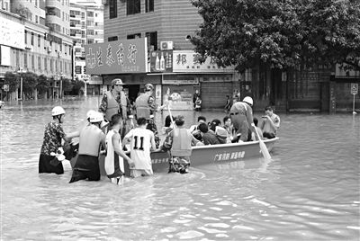 18日，廣東省清遠(yuǎn)市陽(yáng)山縣縣城,消防官兵合力推動(dòng)沖鋒舟，轉(zhuǎn)移被困學(xué)生。新華社發(fā)